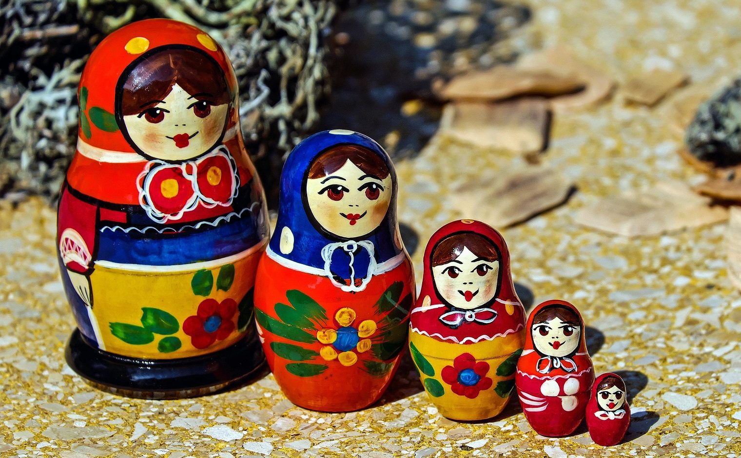 Five colorful matryoshka nesting dolls lined up by size to visually represent different stages and layers of emotional regulation techniques.