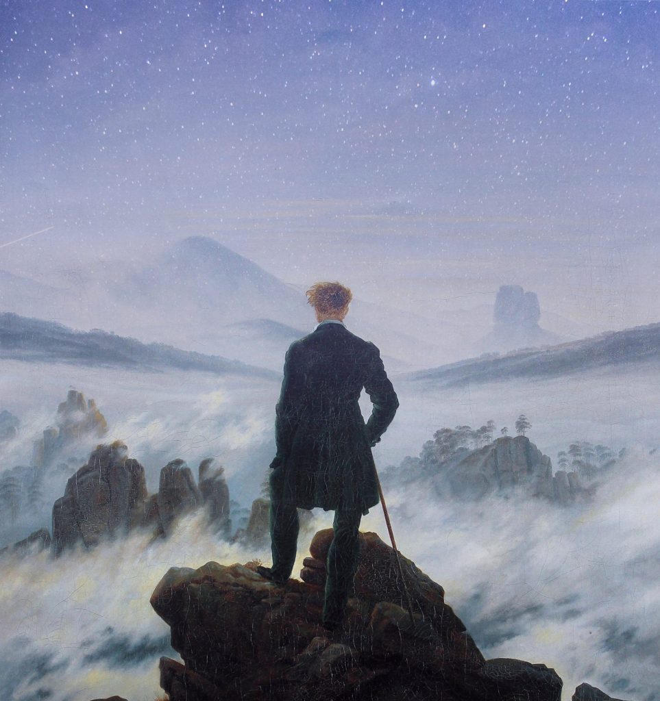 A lone figure stands on a rocky cliff above the clouds under a starry night sky, symbolizing how to practice acceptance while facing life's uncertainty.