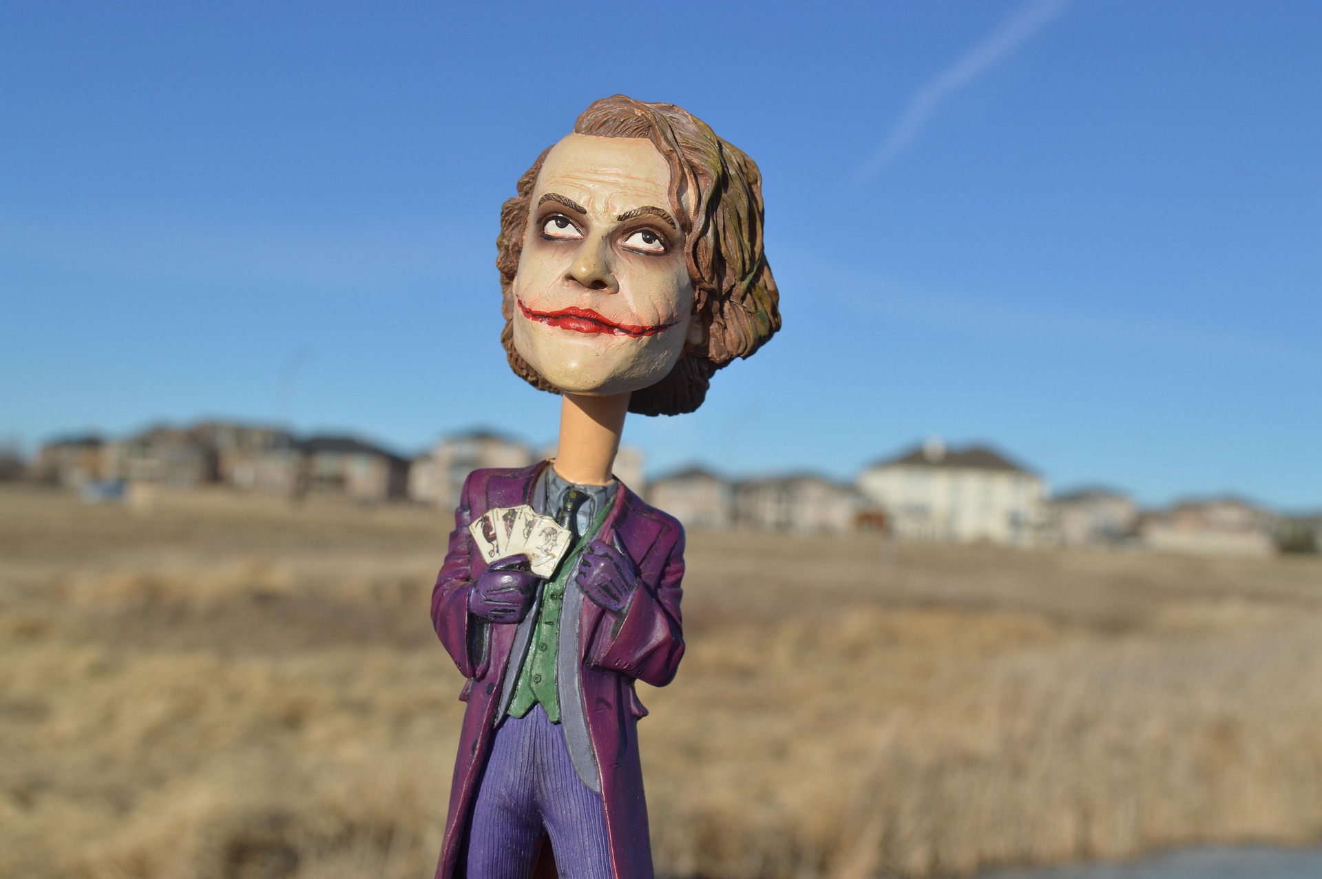 Joker bobblehead figure holding playing cards, symbolizing reconnecting with inner child through play